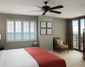 king room with fan, TV, and sea views at Kingston Plantation Condos.