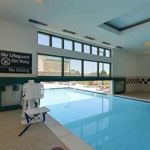 Indoor pool with seating and accessible to otherwise-abled guests at Hampton Inn & Suites Pueblo-Southgate.