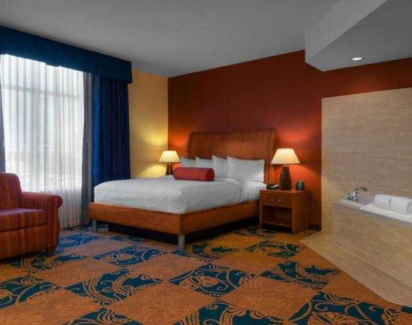 Comfortable king guestroom with window and whirlpool at the Hilton Garden Inn Fort Worth Medical Center.