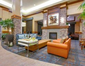 Stylish lobby workspace with fireplace and lounges at the Hilton Garden Inn Fort Worth Medical Center.