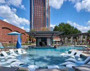 beautiful outdoor pool with sun beds and seating at Hilton Anatole.