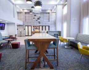 Hotel lobby with sofas, tables and chairs at the Hampton Inn & Suites North Attleboro.