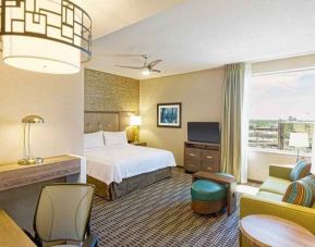 spacious king suite with work area and TV at Homewood Suites by Hilton Houston Downtown.