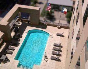 gorgeous outdoor pool with sunbeds and seating at Homewood Suites by Hilton Houston Downtown.