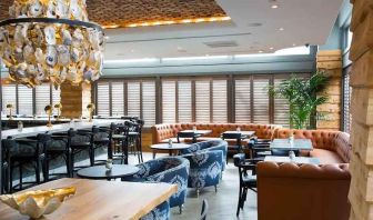Comfortable lobby and restaurant area ideal as a coworking space at The Sam Houston, Curio Collection by Hilton.