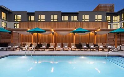 gorgeous outdoor pool with sun beds and seating area at Embassy Suites by Hilton Boulder.