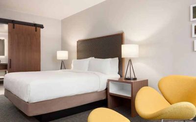 beautiful king room with lounge area at Hilton Garden Inn Boulder.