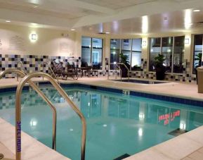 relaxing indoor pool with comfortable seating at Hilton Garden Inn St. Louis Airport.