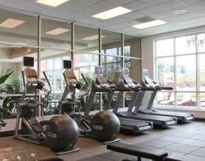 Fitness center with treadmills and windows at the Embassy Suites by Hilton Charleston Airport Convention Center.