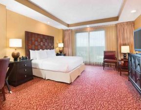 Spacious presidential suite with window, desk and TV screen at the Embassy Suites by Hilton Nashville SE Murfreesboro.