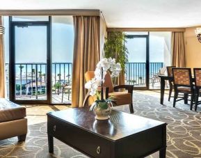 Spacious and elegant presidential room with sofa, table and view at the Hilton Galveston Island Resort.