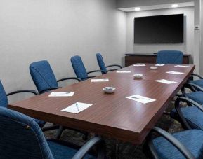 Small meeting room with TV screen at the Hampton Inn Concord Bow.