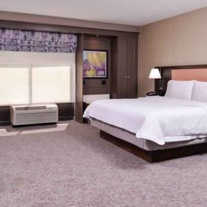 Spacious and bright king guestroom with window and desk at the Hampton Inn Albuquerque, University-Midtown (UNM).