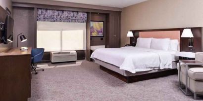 Spacious and bright king guestroom with window and desk at the Hampton Inn Albuquerque, University-Midtown (UNM).