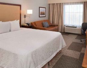 lovely king room with work desk and natural light ideal for working remotely at Hampton Inn & Suites Schertz.
