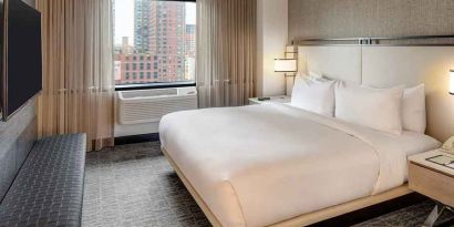 relaxing delux king room with TV at DoubleTree by Hilton Hotel & Suites Jersey City.