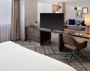 King suite with working station, TV screen and sofa at the DoubleTree by Hilton Tulsa-Downtown.
