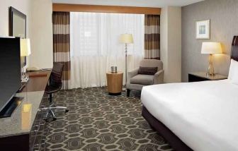 Comfortable and bright king bedroom at the DoubleTree by Hilton Tulsa-Downtown.