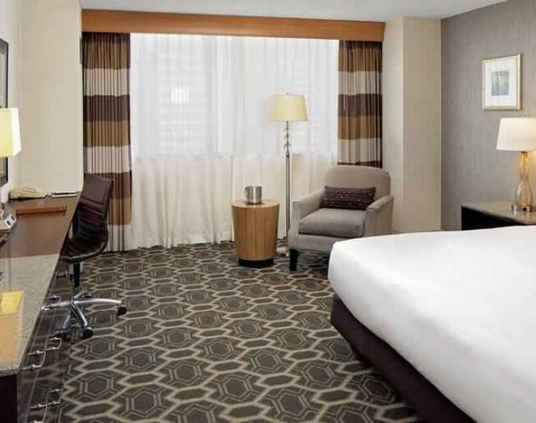 Comfortable and bright king bedroom at the DoubleTree by Hilton Tulsa-Downtown.