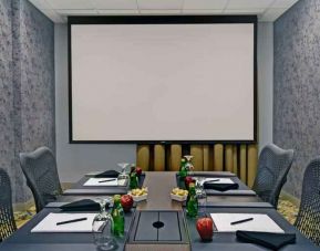 Meeting room with screen at the Hilton Garden Inn Houston Galleria Area.