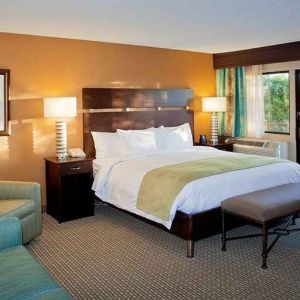 spacious king suite with balcony seating and lounge area at DoubleTree by Hilton Hotel Santa Fe.