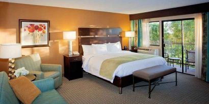 spacious king suite with balcony seating and lounge area at DoubleTree by Hilton Hotel Santa Fe.