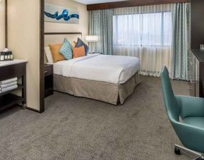 Spacious king room with work desk ideal for working remotely at Embassy Suites by Hilton Seattle Tacoma International Airport.