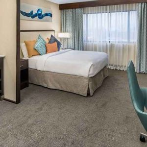Spacious king room with work desk ideal for working remotely at Embassy Suites by Hilton Seattle Tacoma International Airport.