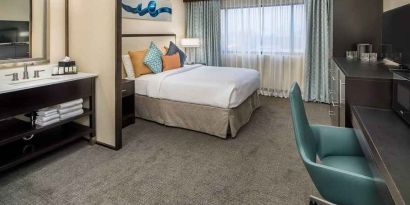 Spacious king room with work desk ideal for working remotely at Embassy Suites by Hilton Seattle Tacoma International Airport.