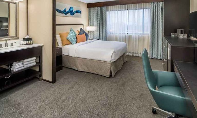 Spacious king room with work desk ideal for working remotely at Embassy Suites by Hilton Seattle Tacoma International Airport.