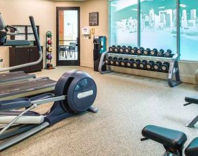 Fully equipped fitness center with treadmills and weights at at Embassy Suites by Hilton Seattle Tacoma International Airport.