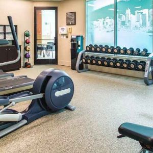Fully equipped fitness center with treadmills and weights at at Embassy Suites by Hilton Seattle Tacoma International Airport.