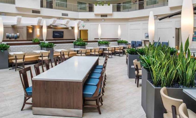 Comfortable lobby lounge area ideal as a coworking space at Embassy Suites by Hilton Seattle Tacoma International Airport.