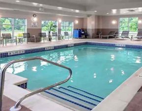 large indoor pool with sunbeds and seating area at Hampton Inn Cranbury.