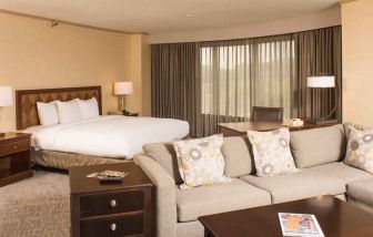 Spacious and comfortable king suite with sofa at the DoubleTree by Hilton Tulsa - Warren Place.