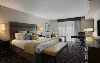 Presidential suite with king size bed and desk at the Embassy Suites by Hilton Napa Valley.