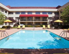 Outdoor pool area with lounges at the DoubleTree Suites by Hilton Cincinnati-Blue Ash.