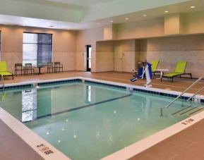 Indoor pool area with lounges and chairs at the Hampton Inn & Suites St. Paul Oakdale/Woodbury by Hilton.