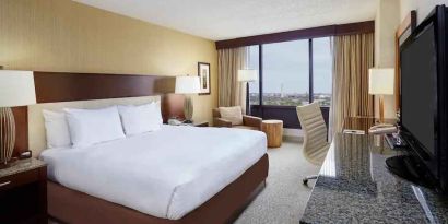 Comfortable king size bed in a hotel guestroom at the DoubleTree by Hilton Washington DC - Crystal City.