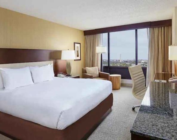 Comfortable king size bed in a hotel guestroom at the DoubleTree by Hilton Washington DC - Crystal City.