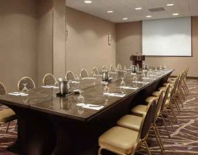 Meeting room with screen at the Embassy Suites by Hilton Crystal City National Airport.