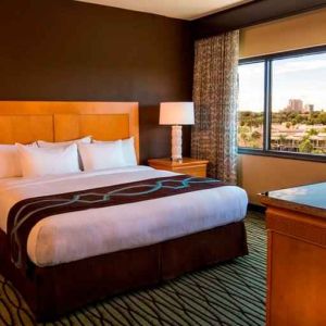 King suite with TV screen and window at the DoubleTree Suites by Hilton Orlando - Disney Springs Area.