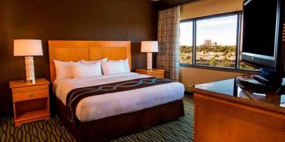 King suite with TV screen and window at the DoubleTree Suites by Hilton Orlando - Disney Springs Area.