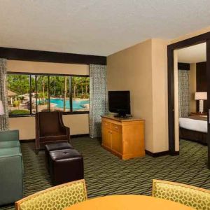 Spacious living room with working station at the DoubleTree Suites by Hilton Orlando - Disney Springs Area.