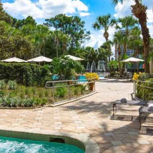 Beautiful outdoor patio with plants by the pool at the DoubleTree Suites by Hilton Orlando - Disney Springs Area.