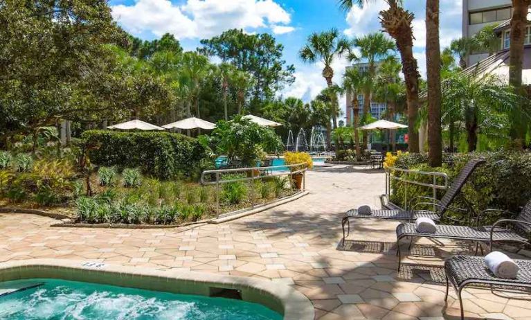 Beautiful outdoor patio with plants by the pool at the DoubleTree Suites by Hilton Orlando - Disney Springs Area.