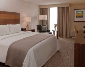 King guestroom with desk and TV screen at the DoubleTree by Hilton Pittsburgh Green Tree.