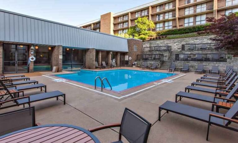 Outdoor pool with lounges at the DoubleTree by Hilton Pittsburgh Green Tree.