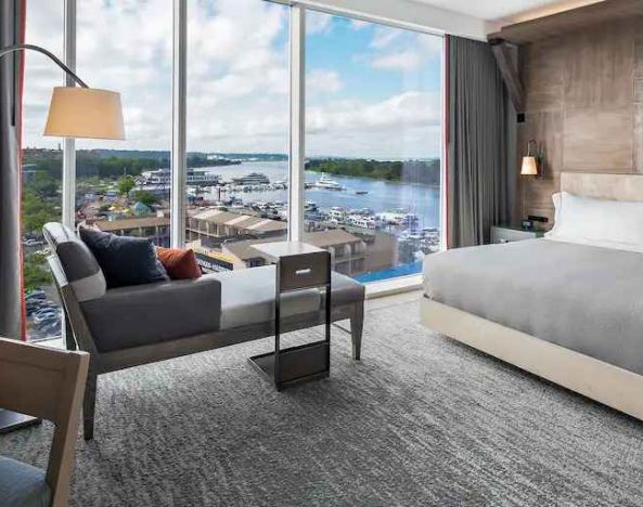 Bright king bedroom with lounge overlooking the water at the Canopy by Hilton Washington DC The Wharf.