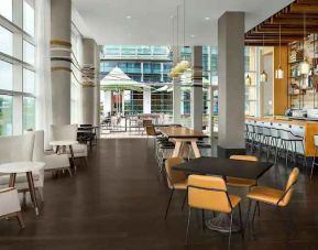 Lobby workspace with tables and chairs at the Canopy by Hilton Washington DC The Wharf.